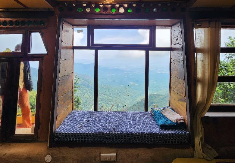 Warm, rustic room interior at Shanti Earth with wooden decor and natural lighting